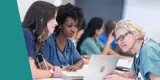 A healthcare professor showing two students something on a laptop