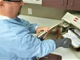 Dental assistant is disinfecting and sterilizing