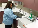 Dental assistant is disinfecting and sterilizing