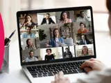 A laptop showing an online meeting